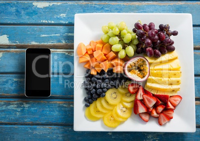 Phone on blue wooden desk with food