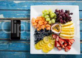 Phone on blue wooden desk with food