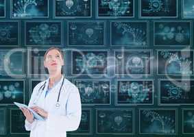 Woman doctor looking up against background with 3d medical interfaces
