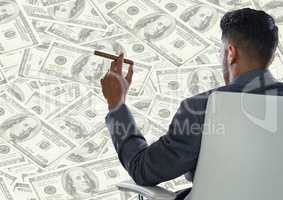Back of business man in chair against money backdrop