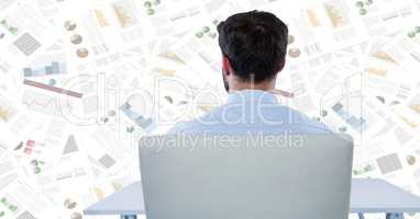 Back of business man at desk against document backdrop