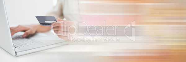 Close up of woman online shopping with blurry orange transition