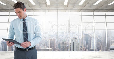 businessman with tablet in cityscape