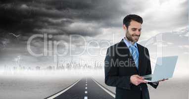 businessman on laptop in cityscape