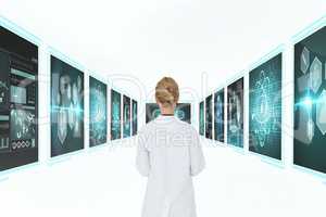 Woman doctor looking at medical interfaces against white background 3d
