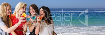 Women with cocktails against water