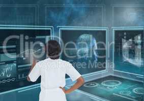 Woman interacting with 3d medical interfaces against blue background with flares