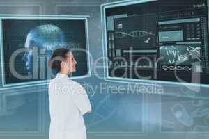 Happy woman doctor looking at 3d medical interfaces