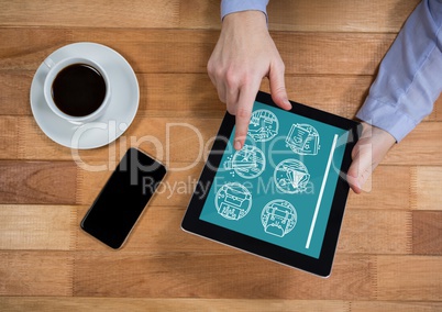 Man holding a tablet with travel icons on the screen