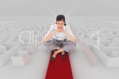 Woman sitting on a 3d maze with an arrow