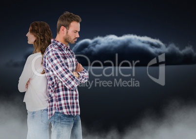 Couple facing back to back and upset with clouds