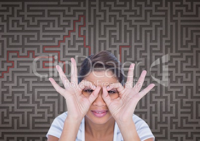 Woman doing binoculars symbols against 3d maze background