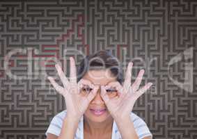 Woman doing binoculars symbols against 3d maze background