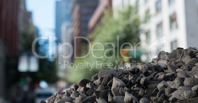 Rubble stones in pile with cityscape