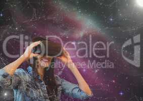 Happy woman in VR headset looking to a pink galaxy background