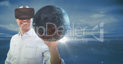 Happy man in VR touching 3D planet with flares against blue sky