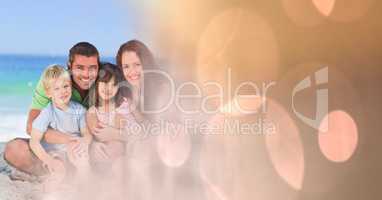 Family at beach with peach bokeh transition