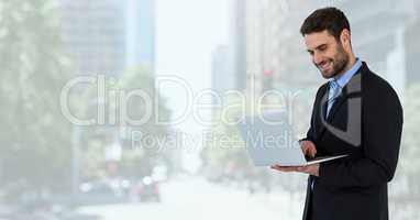 businessman on tablet in cityscape