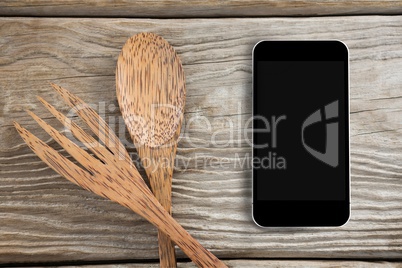 Phone on wooden desk and copy space on mobile phone