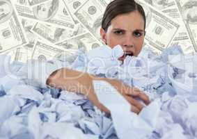Woman covered in crumpled paper against money backdrop