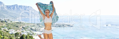 Woman in underwear with blanket celebrating against blurry coastline 3d