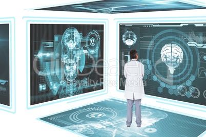 Man doctor looking at medical interfaces against white 3d background