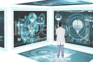 Man doctor looking at medical interfaces against white 3d background