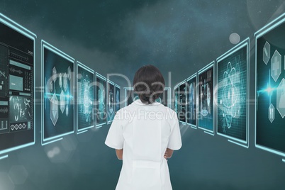 Woman doctor looking at 3d medical interfaces