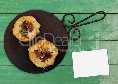 Bussiness card on green wooden desk with food and copy space