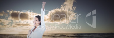 Business woman celebrating against water and sunset 3d