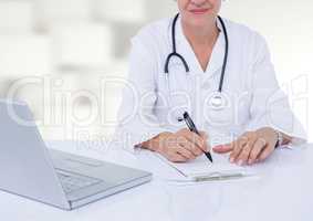 Doctor writing at desk against white blurry pattern