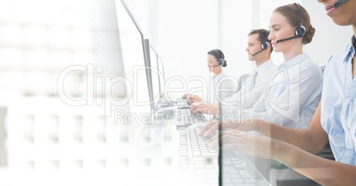 Customer service assistants  with headsets with bright office background