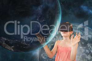 Girl in VR headset touching a 3D planet against a blue sky with planet and stars