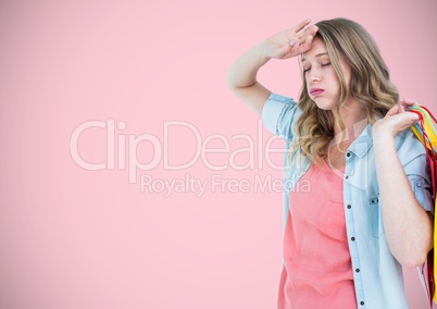 Tired shopper with bags against pink background