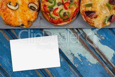 Bussiness card on blue wooden desk with food and copy space on a card