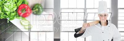 Chef holding rolling pin with salad and windows background and copy space