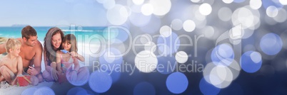 Family at beach with bucket and spade with blue bokeh transition