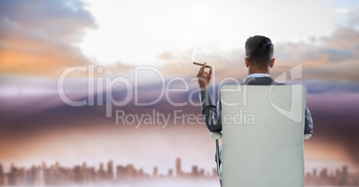 businessman in chair in city sky