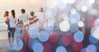 Back of family at beach with red and blue bokeh transition