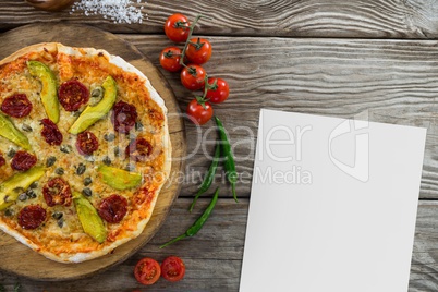 Blank card on wooden desk with food and white copy space