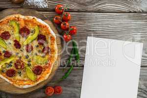 Blank card on wooden desk with food and white copy space