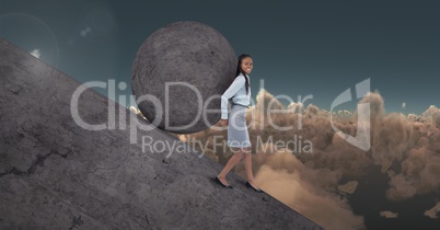 Woman pushing rolling round rock