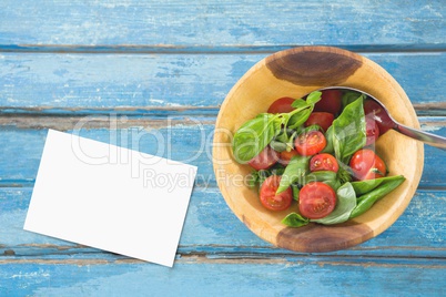 Bussiness card on blue wooden desk with food and copy space on paper