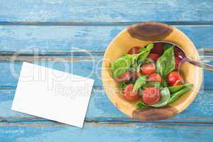 Bussiness card on blue wooden desk with food and copy space on paper