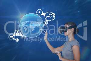 Woman in VR headset touching interface against blue background with flares