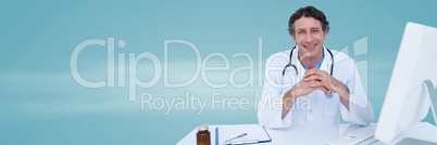 Doctor hands together at desk against blue background