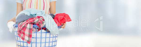 Cleaner  holding laundry basket with bright background