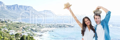 Millennial couple with hats against blurry coastline 3d