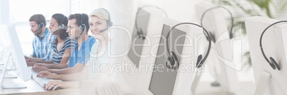 Customer service assistants  with headsets with bright computer background