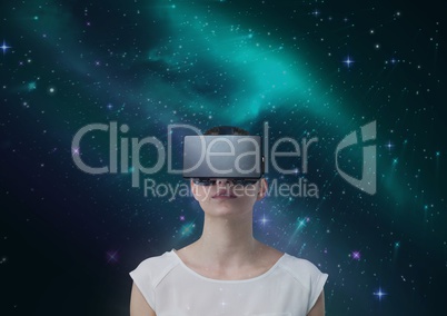 Woman in VR headset against green and purple space background